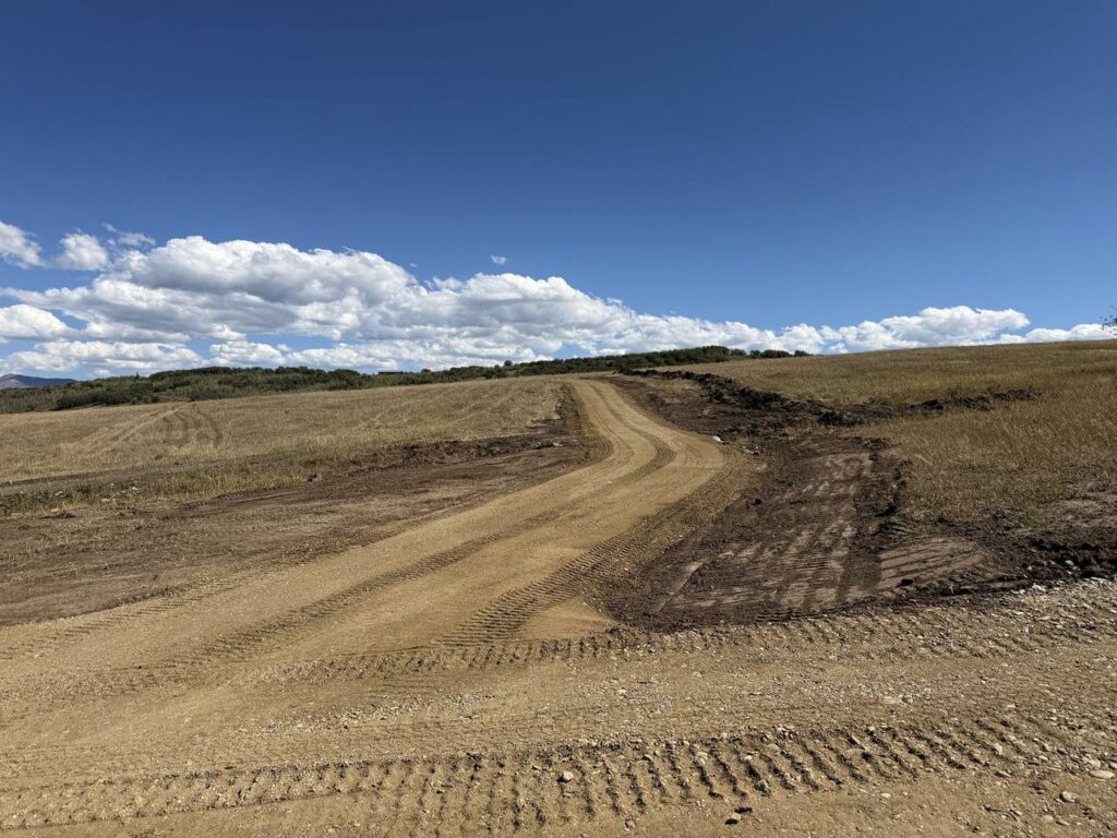 New ranch access road cut and graded across open pasture in South Routt County, Colorado